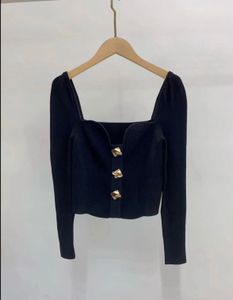 Chic Black Top with gold buttons