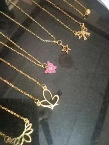 Set of dainty gold necklaces with charms