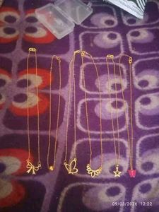 Set of dainty gold necklaces with charms