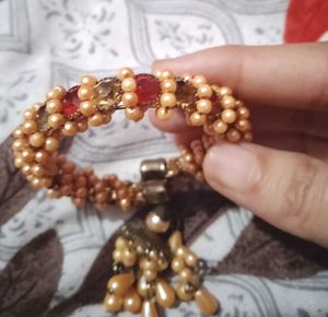 Elegant Golden Beaded Bracelet with Red Stones