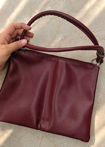 Clinique burgundy Leather Bag.