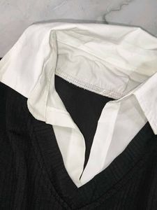 A great black top with white sleeves and collar.