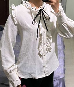 Ruffled White Blouse with Black Bow