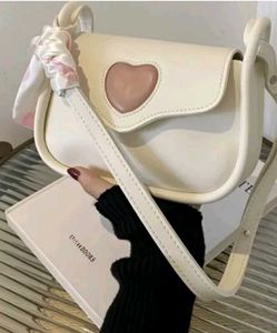 white handbag along with a cute ribbon 🎀