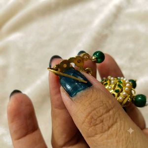 Elegant Gold Jhumka Earrings with Green Beads