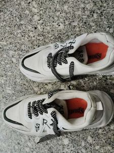 Stylish White Sneakers with Black Laces