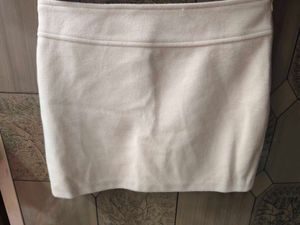 cream colour short skirt.