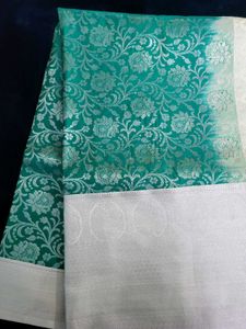 Elegant Teal Saree with Silver Floral Motifs