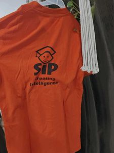 Orange SIP Abacus T-Shirt nd black leggings