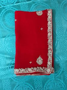 Vibrant Red Saree with Intricate Embellishments