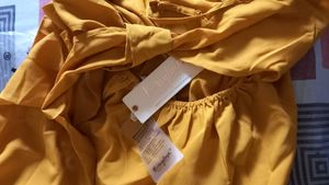 Today's Offer ₹150 Berrylush Women Solid Yellow Front Twist Knot Fit &amp; Flare Mini Dress For Women (Mustard Colour)