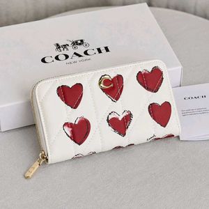Coach Accordion Zip wallet featuring pillow quilti