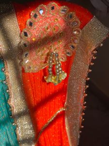 Stunning Blue and orange Net saree with Embellishm