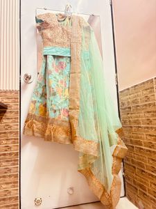 Pastel green lehenga with golden sequin blouse