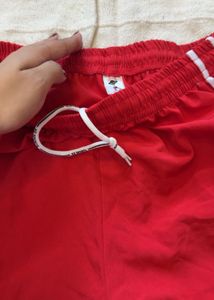Red Track Pants with White Stripes