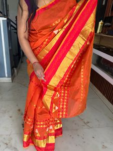 Vibrant Orange Saree with Golden Accents