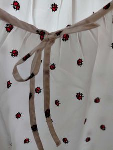 White Top with Red Ladybug Print