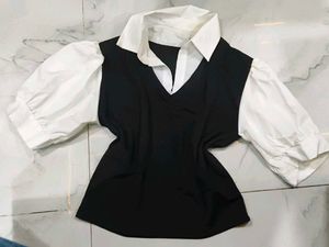 A great black top with white sleeves and collar.