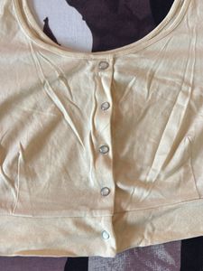 pastel yellow button-down crop top blouse.