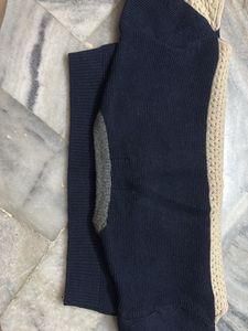 a knit sweater in shades of navy blue and beige