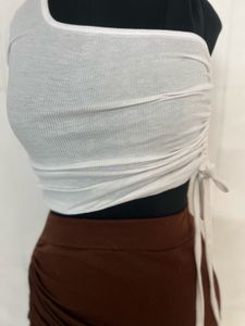 white top and brown skirt