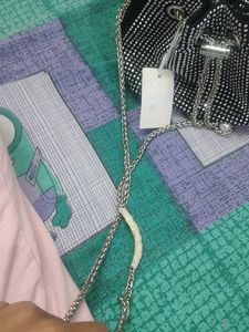 new sling potli bag black and silver in coulour...