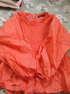 Coral Smocked Peplum Top