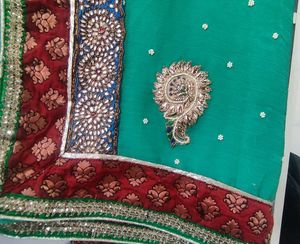 Elegant Teal Saree with Intricate Embellishments