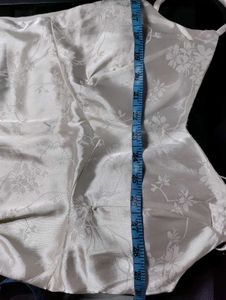 Off-white satin strappy top.