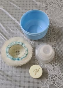 Baby powder puff with a refill container
