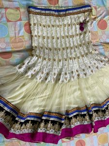 cream colour embroidered  heavy border  full flared lehnga with net heavy border dupatta
