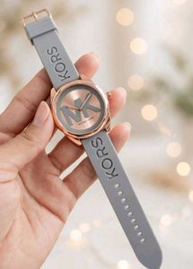 Michael Kors watch with a bold MK logo on the silv