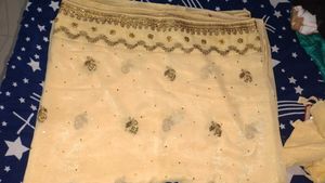 Elegant Cream Saree with Gold Embellishments