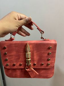 Stylish Red Crossbody Bag with Gold Embellishments