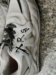 Stylish White Sneakers with Black Laces
