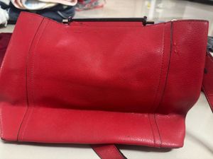 Vibrant Red Handbag with Unique Strap