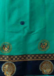 Elegant Teal Saree with Peacock Motif