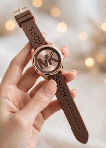 Michael Kors watch with a bold MK logo on the silv