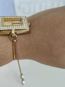 Elegant Gold Watch with Pearl Detail