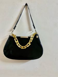 Chic Black Patent Handbag with Gold Chain