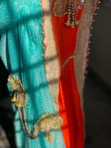 Stunning Blue and orange Net saree with Embellishm