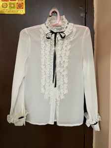 Black Vest with White Ruffle Blouse