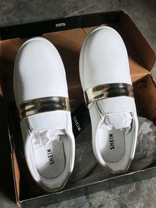 Stylish White Slip-On Sneakers with Gold Accent