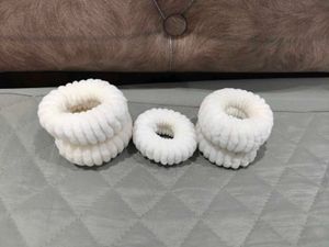 A set of 5 white thick rubberbands