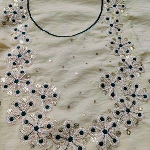 Elegant Cream  dress material with Green Bandhani