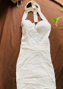 White Bodycon with blackless staps and neck buttoned.