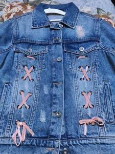 Distressed Denim Jacket with Pink Lace-Up Detail