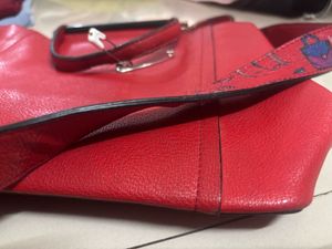Vibrant Red Handbag with Unique Strap