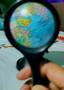 Globe With A Magnifying Glass