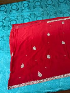 Vibrant Red Saree with Intricate Embellishments